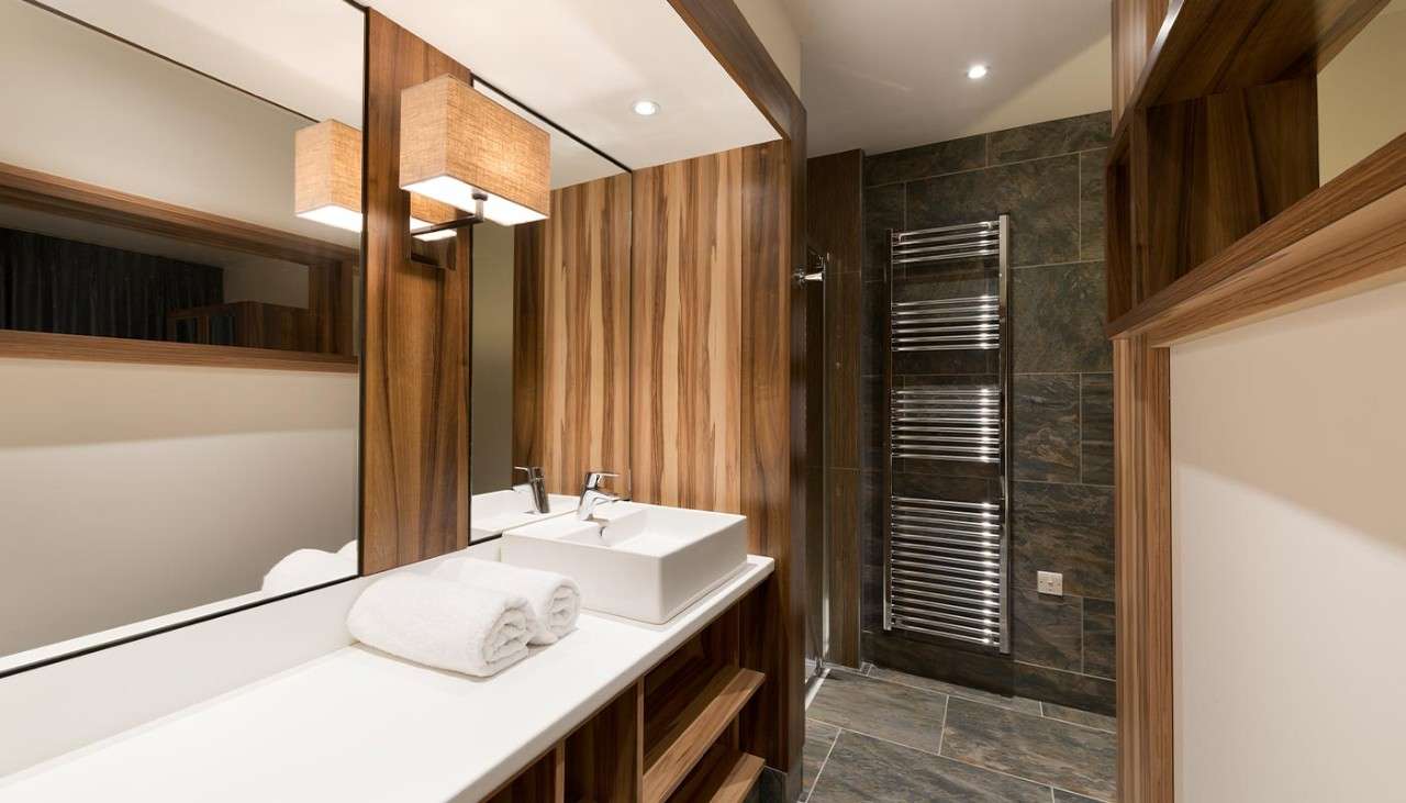 A hotel bathroom showing sink and vanity area. 