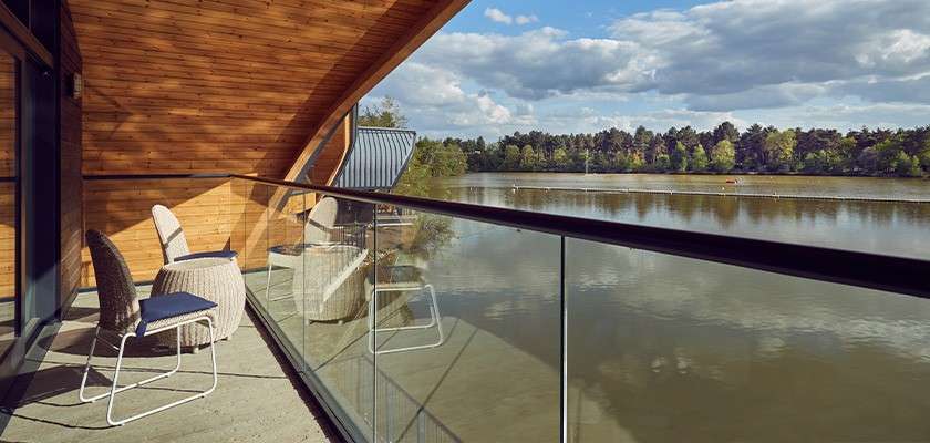 The balcony of a waterside lodge facing out onto the lake