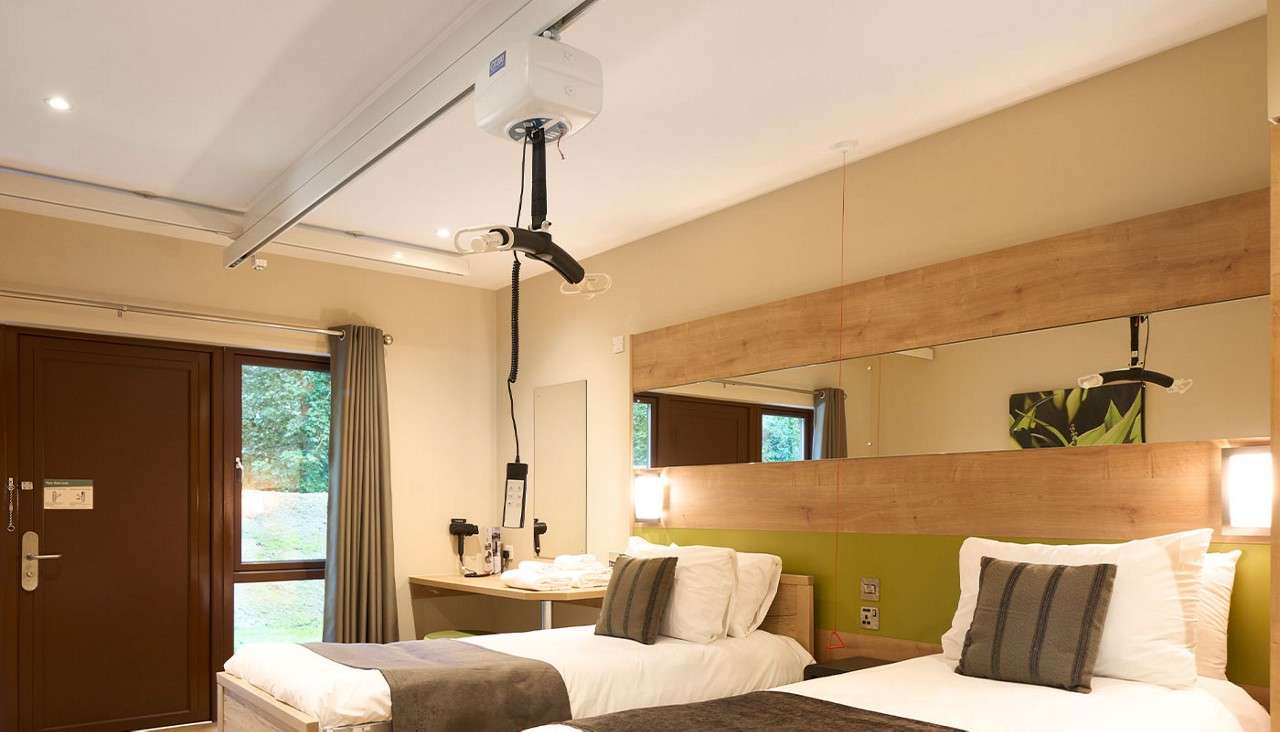 Twin bedroom with electric bed and ceiling hoist