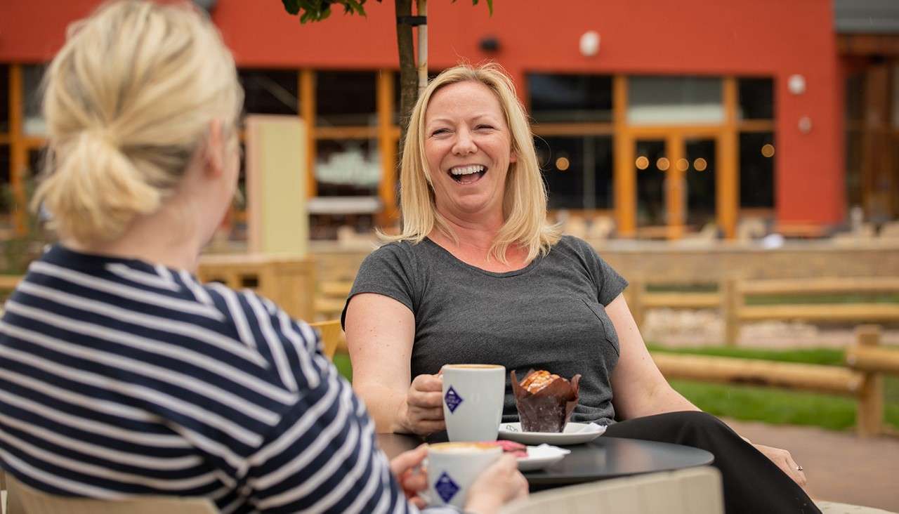 Women enjoying a coffee outside at the coffee house.