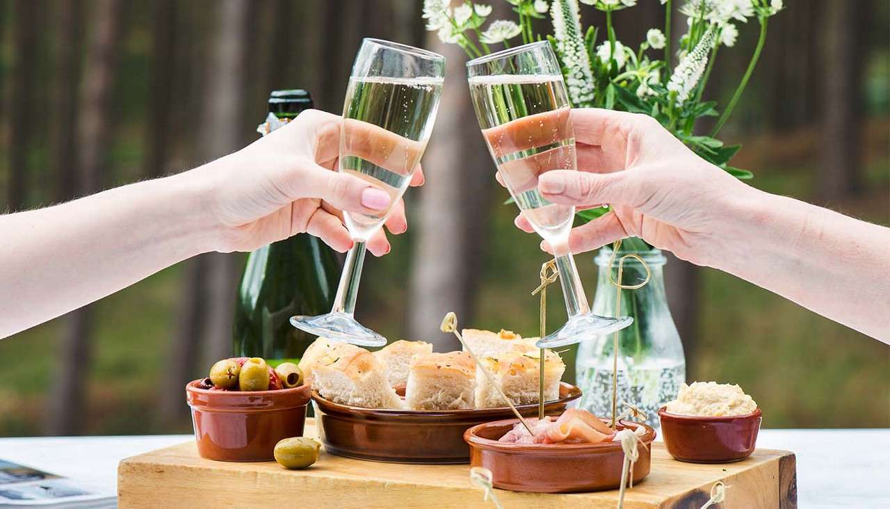 Two people toasting champagne glasses