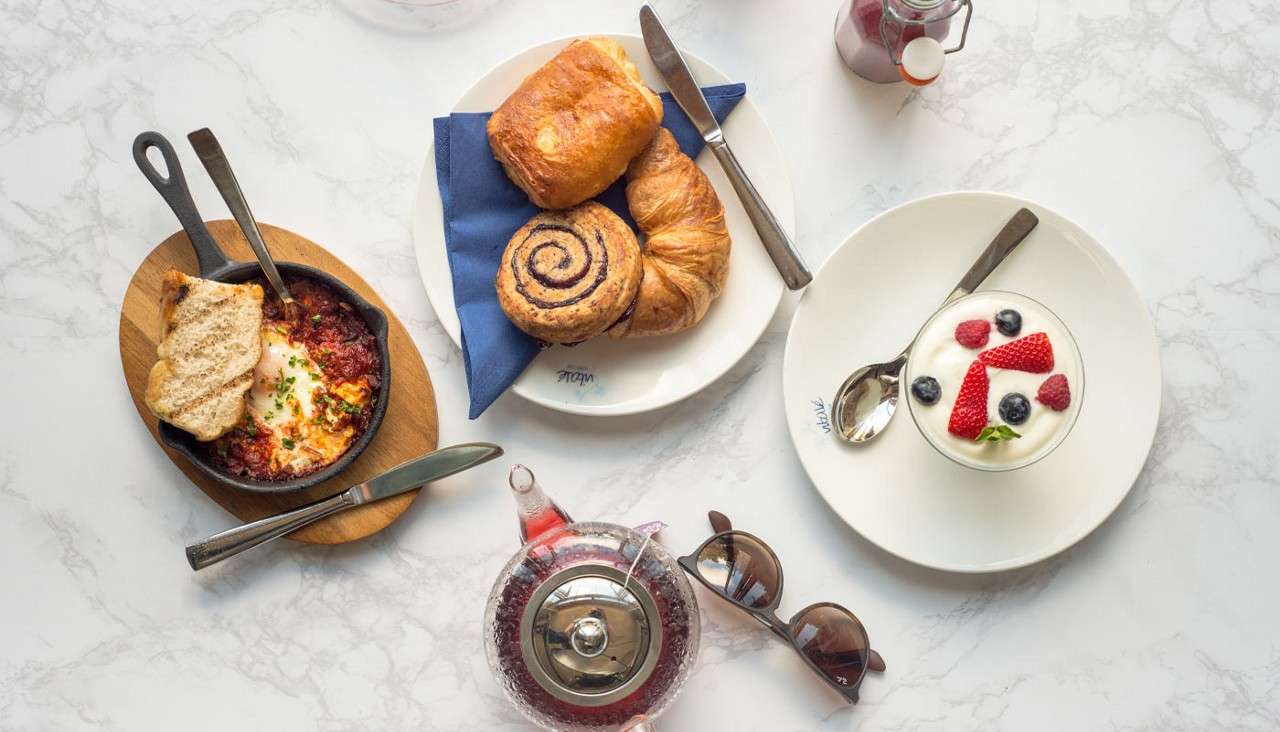 A selection of dishes including oven baked pasta, pastries and a cream pudding.