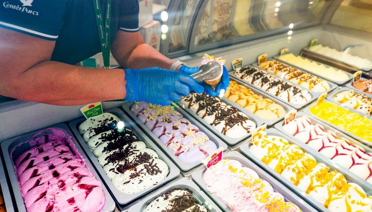 Colourful ice creams topped with tasty toppings.