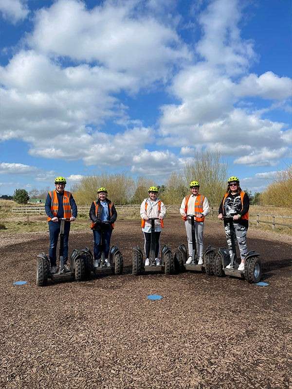 A family riding segways posing for the camera.