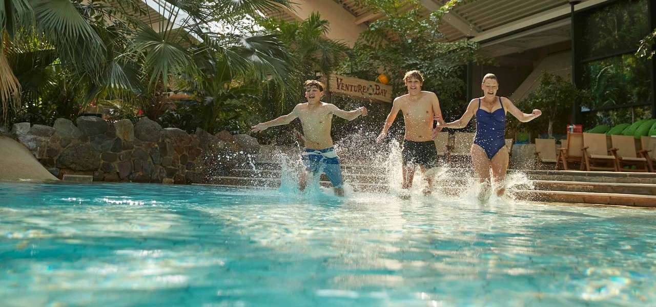 Teenagers and their mother running into the Subtropical Swimming Paradise.