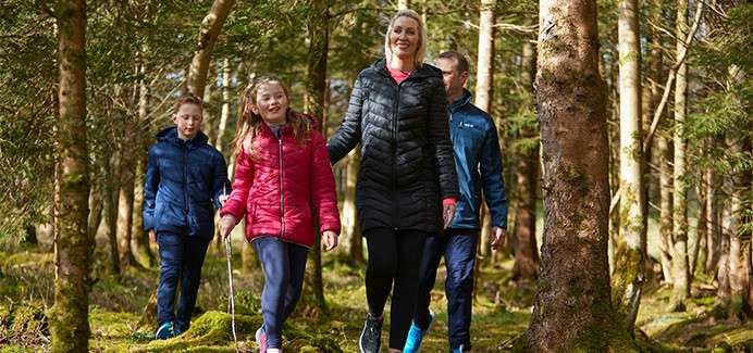 A family walking together through a forest..