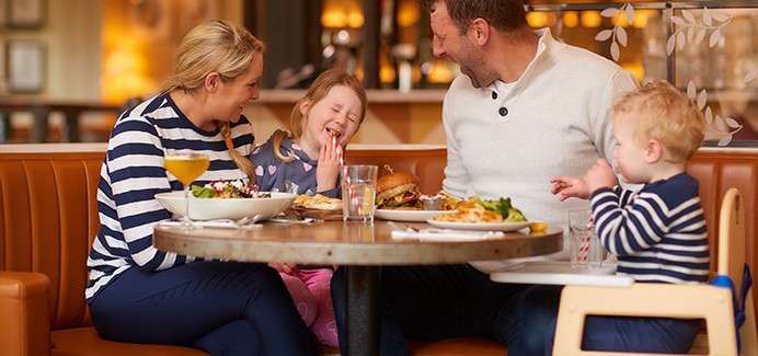  A family dining in a restaurant.