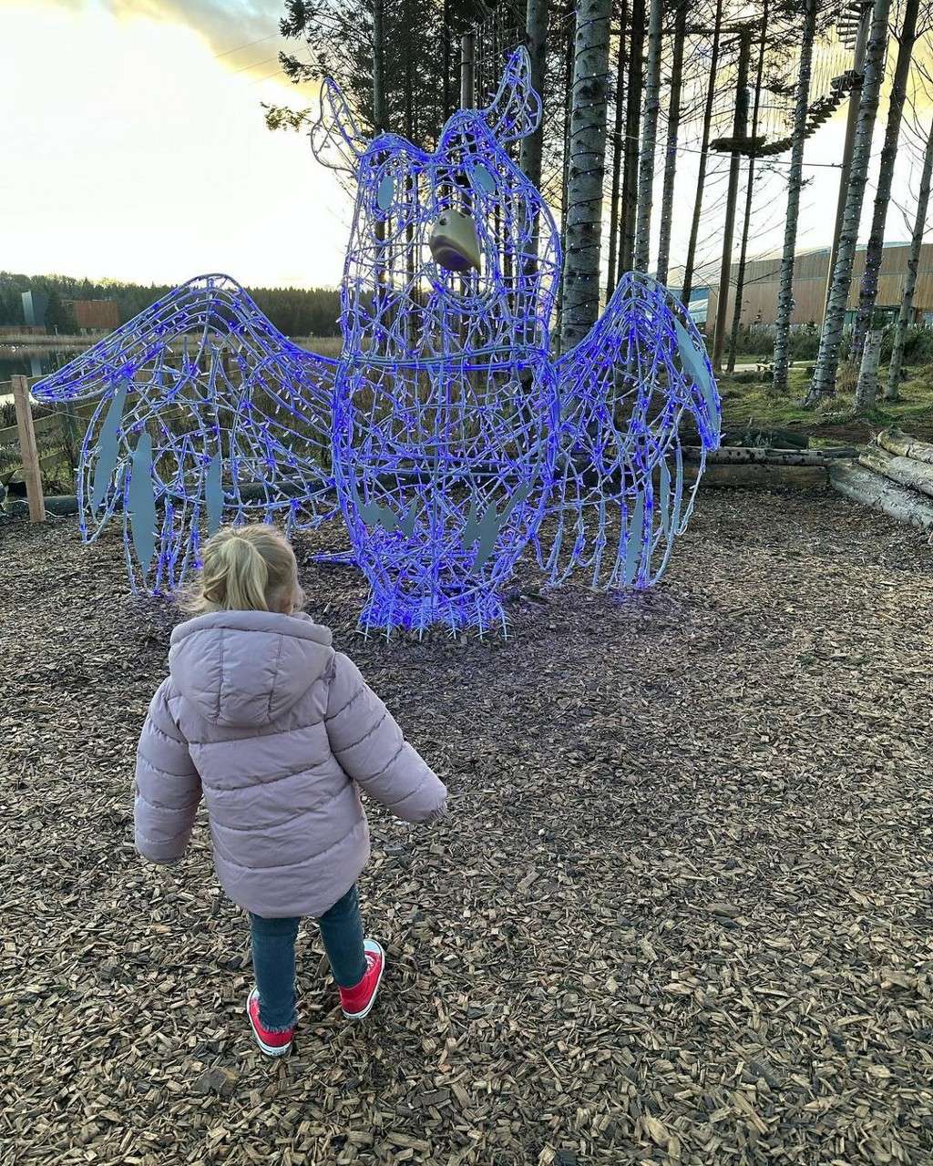 Child looking at a blue owl