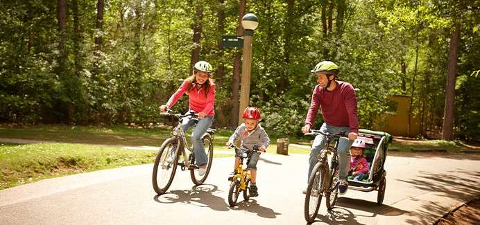 A family cycling through the forest