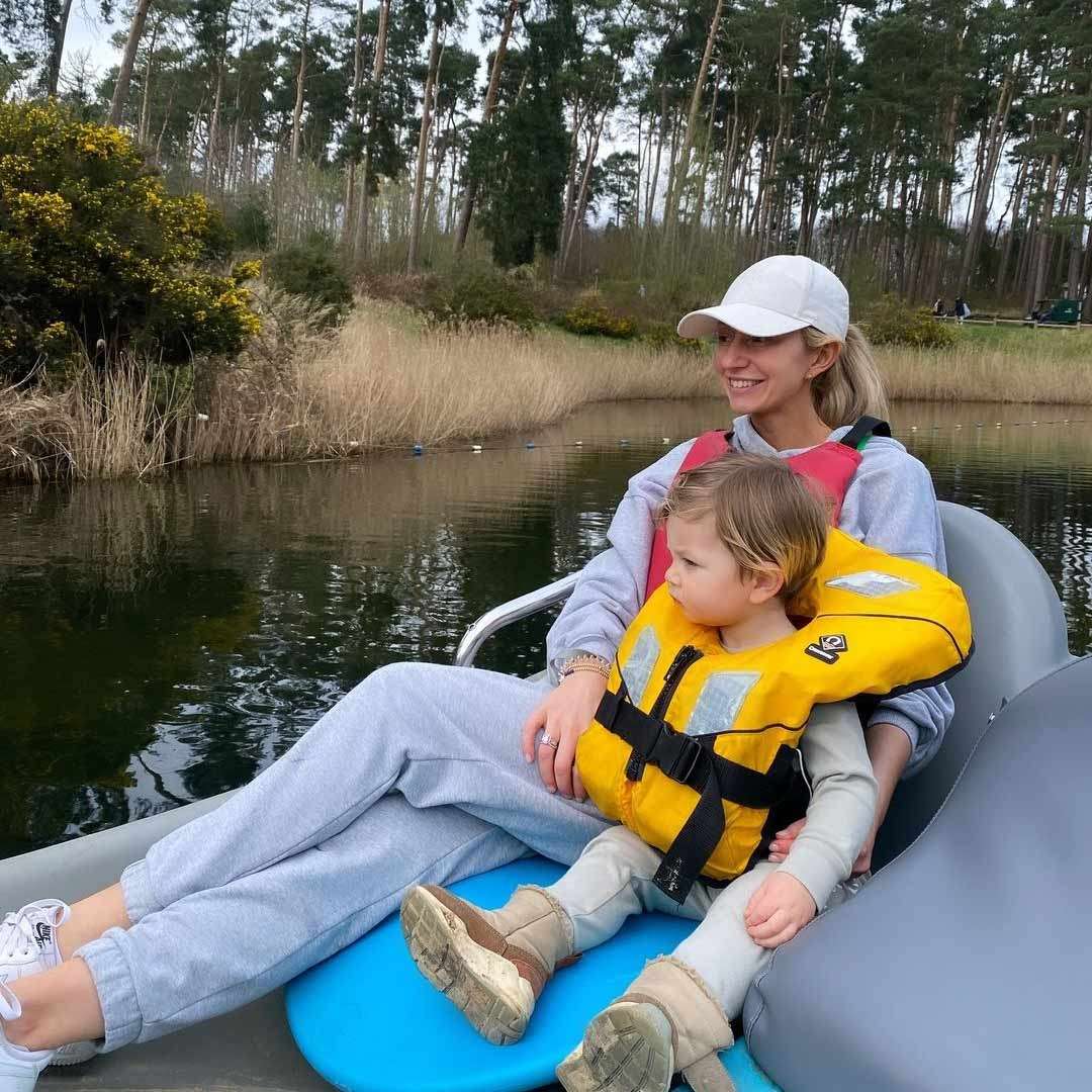 A woman and child sitting in an Electric Boat on the lake