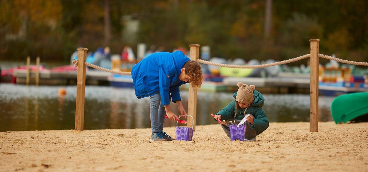 Children making sand castles on the beach.