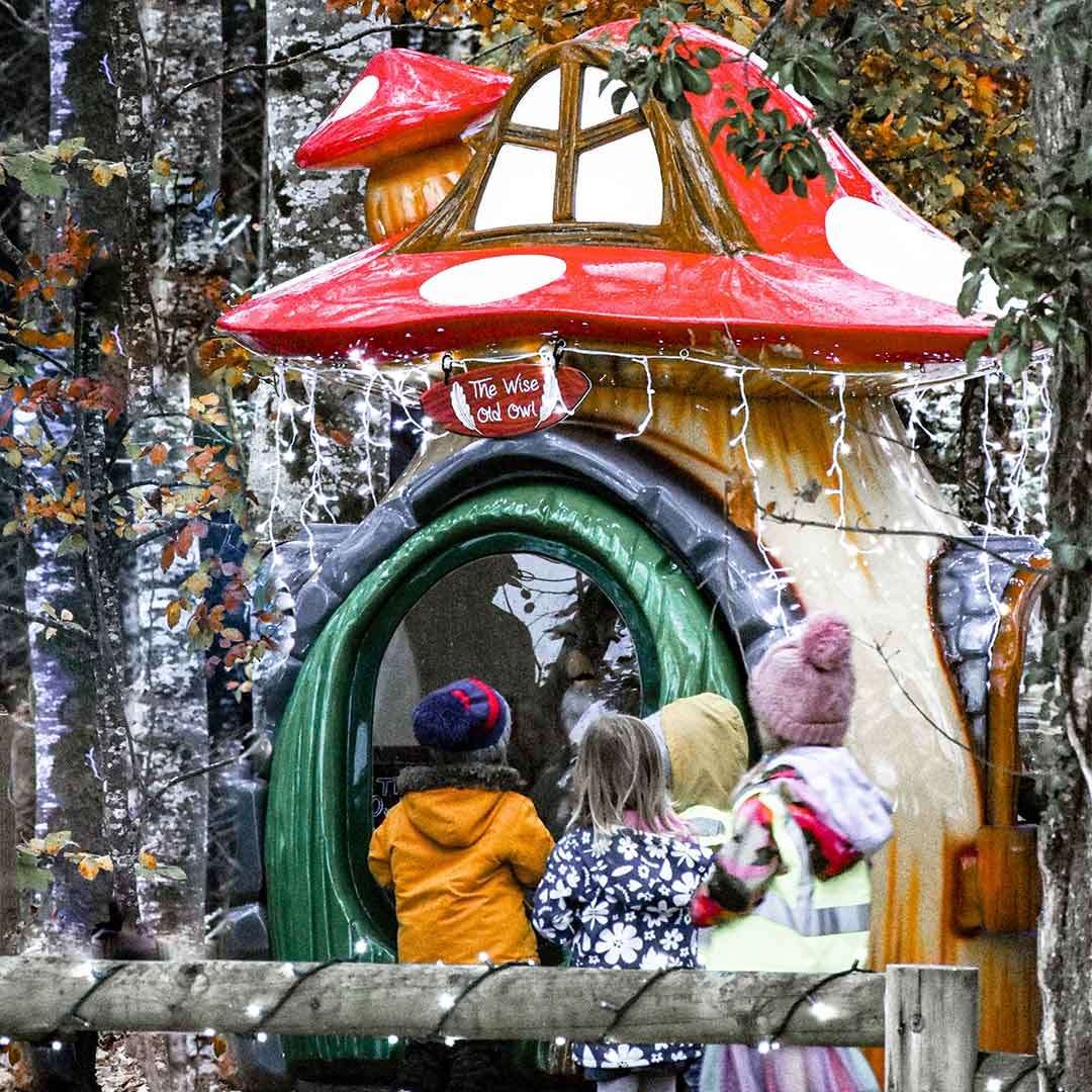 Children looking in the Mushroom house in Winter Wonderland.