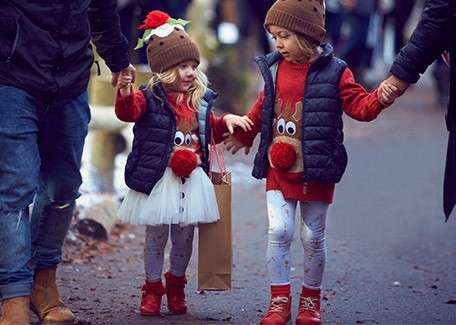 Children dressed as reindeer holding hands