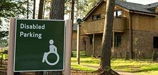 A disabled parking sign outside a lodge