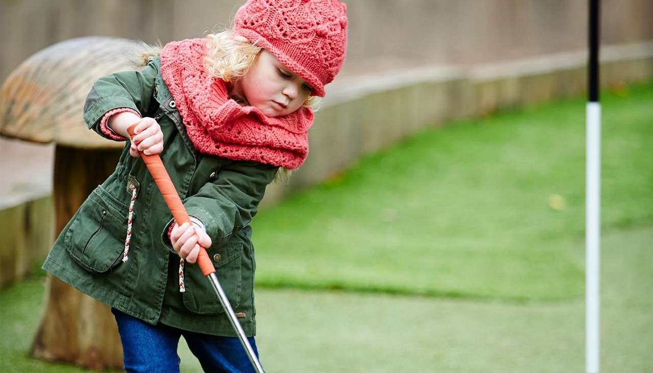 Young girl playing Adventure Golf