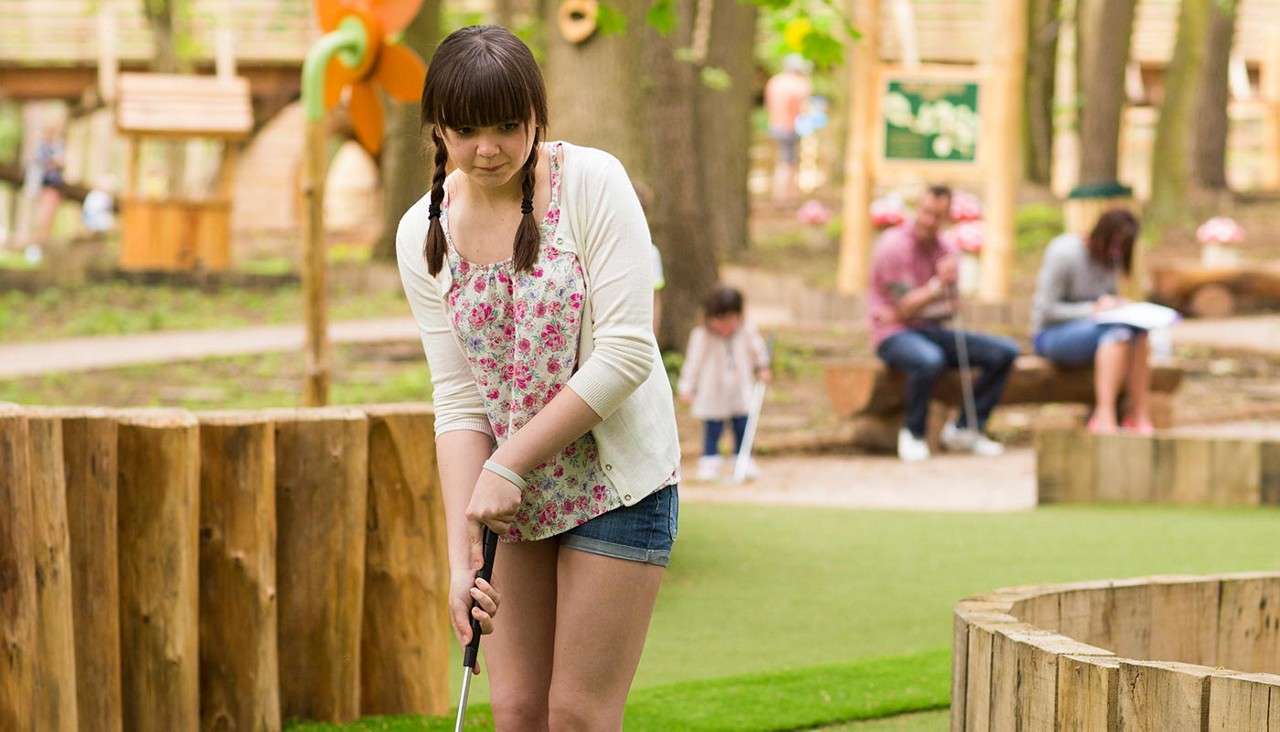 Teenager playing Adventure Golf