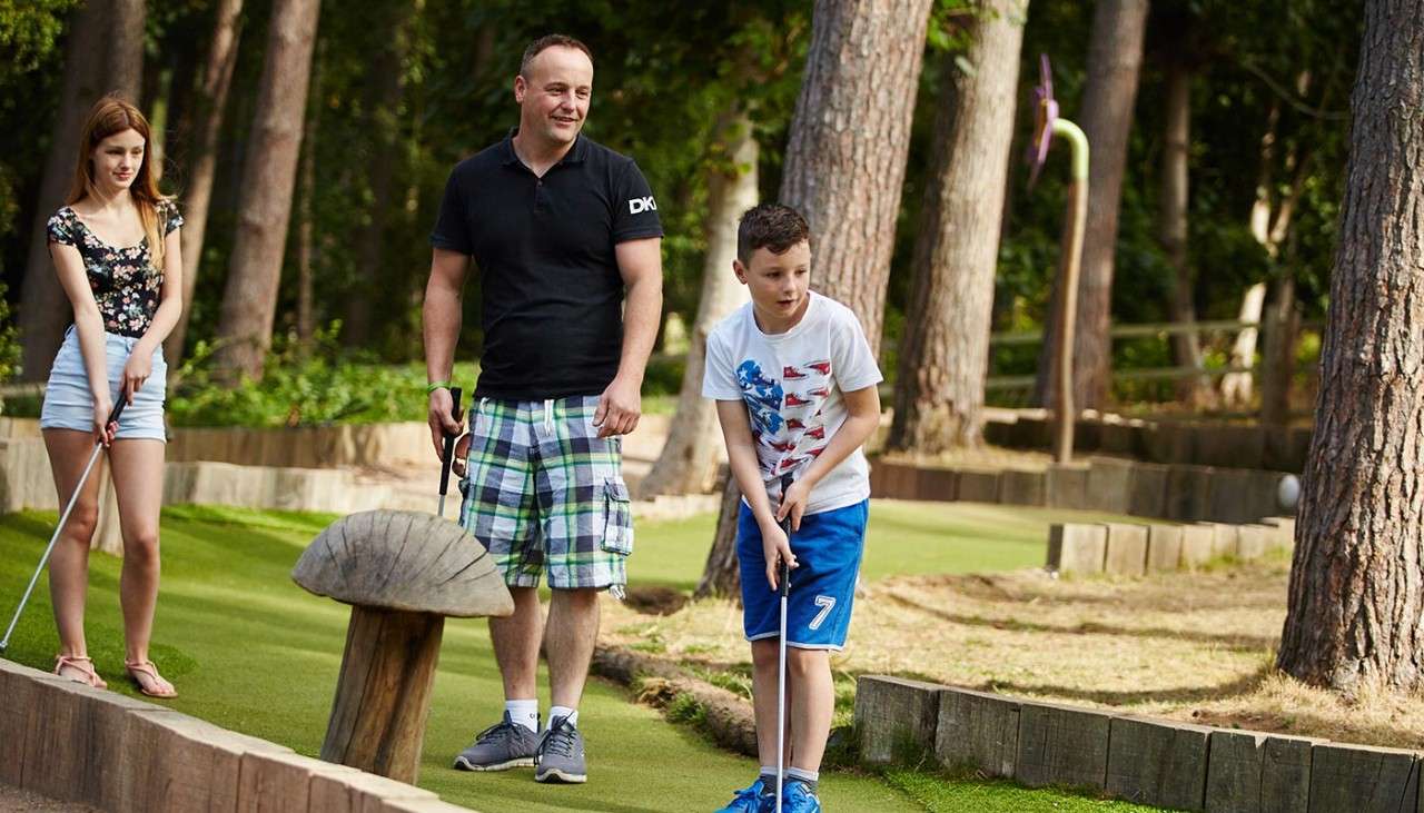 Family playing Adventure Golf
