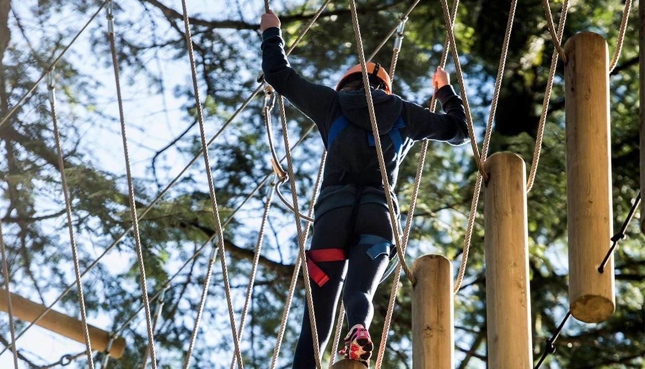 Girl on aerial adventure obstacle