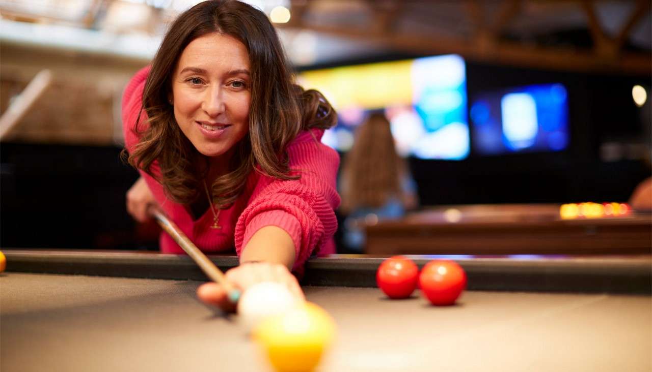 Woman playing pool