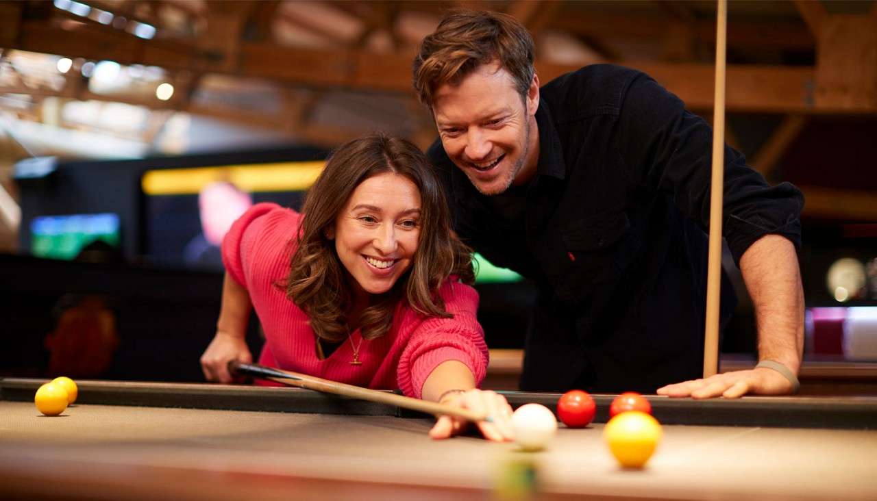 Man and woman playing pool