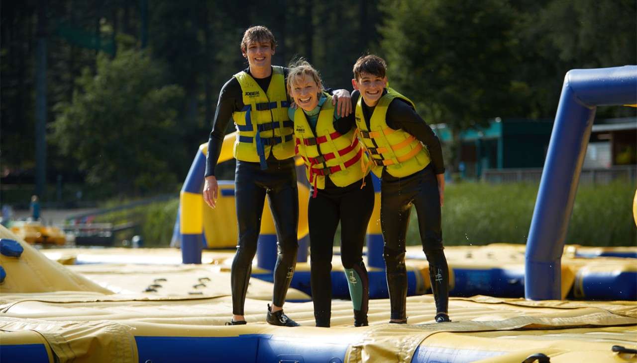 Family posing for a picture on an inflatable floating on the lake.