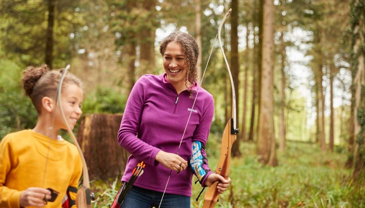 Woman and boy enjoying archery