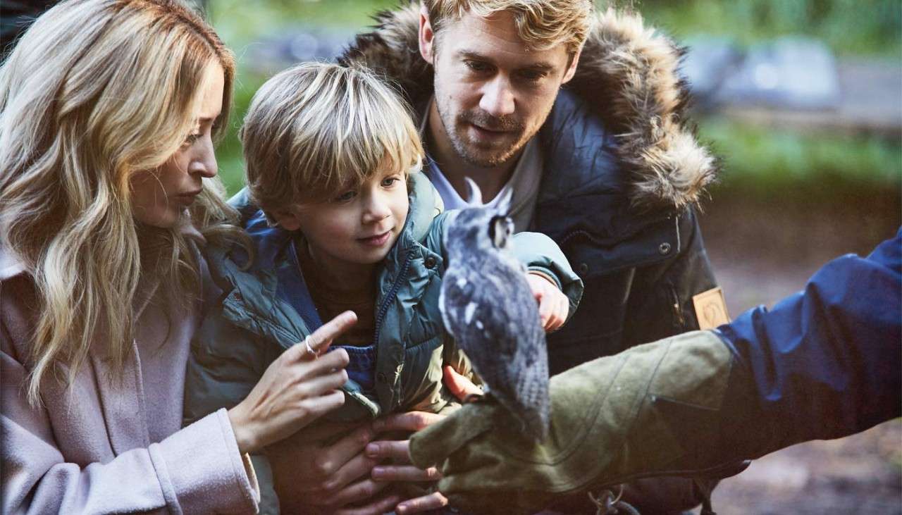 Boy holding a baby owl