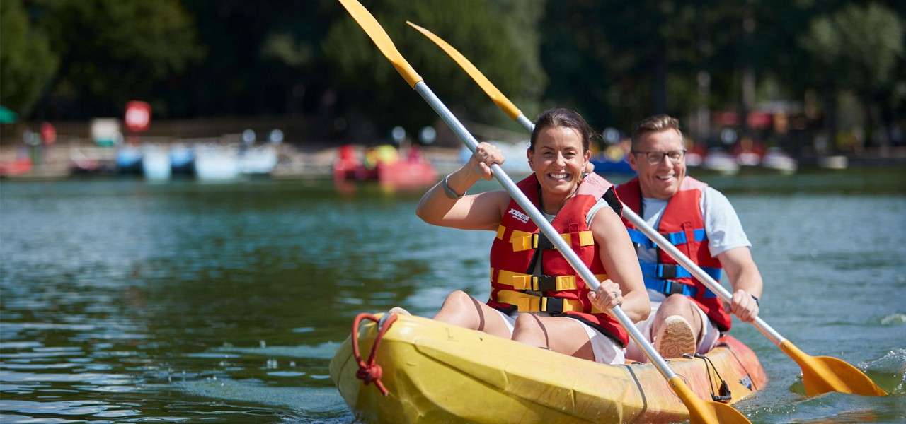 Couple sitting in a Double Kayak on the lake.