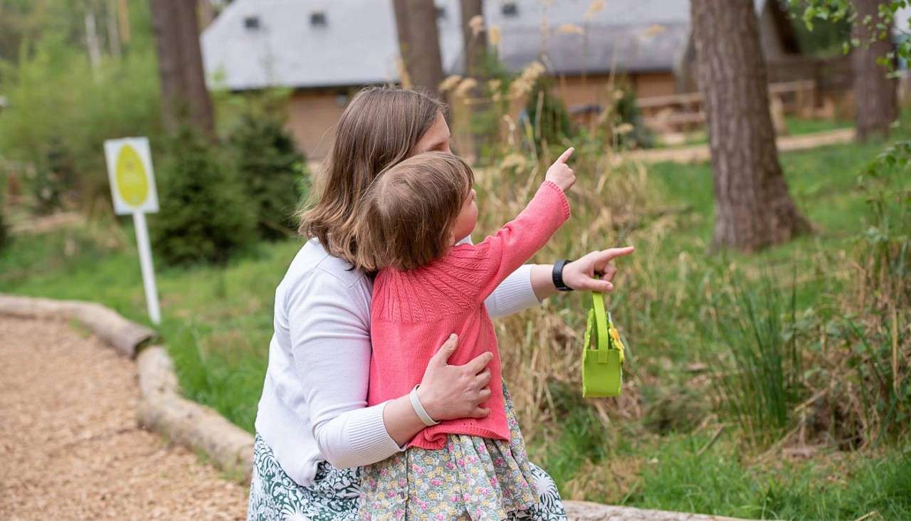 Woman and girl hunting for Easter eggs