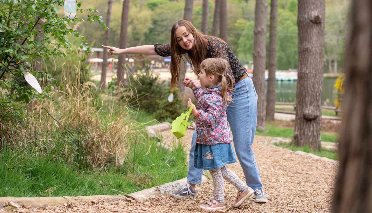 Woman and girl hunting for Easter eggs
