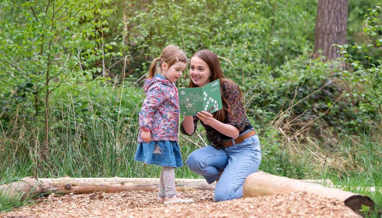 Woman and girl hunting for Easter eggs