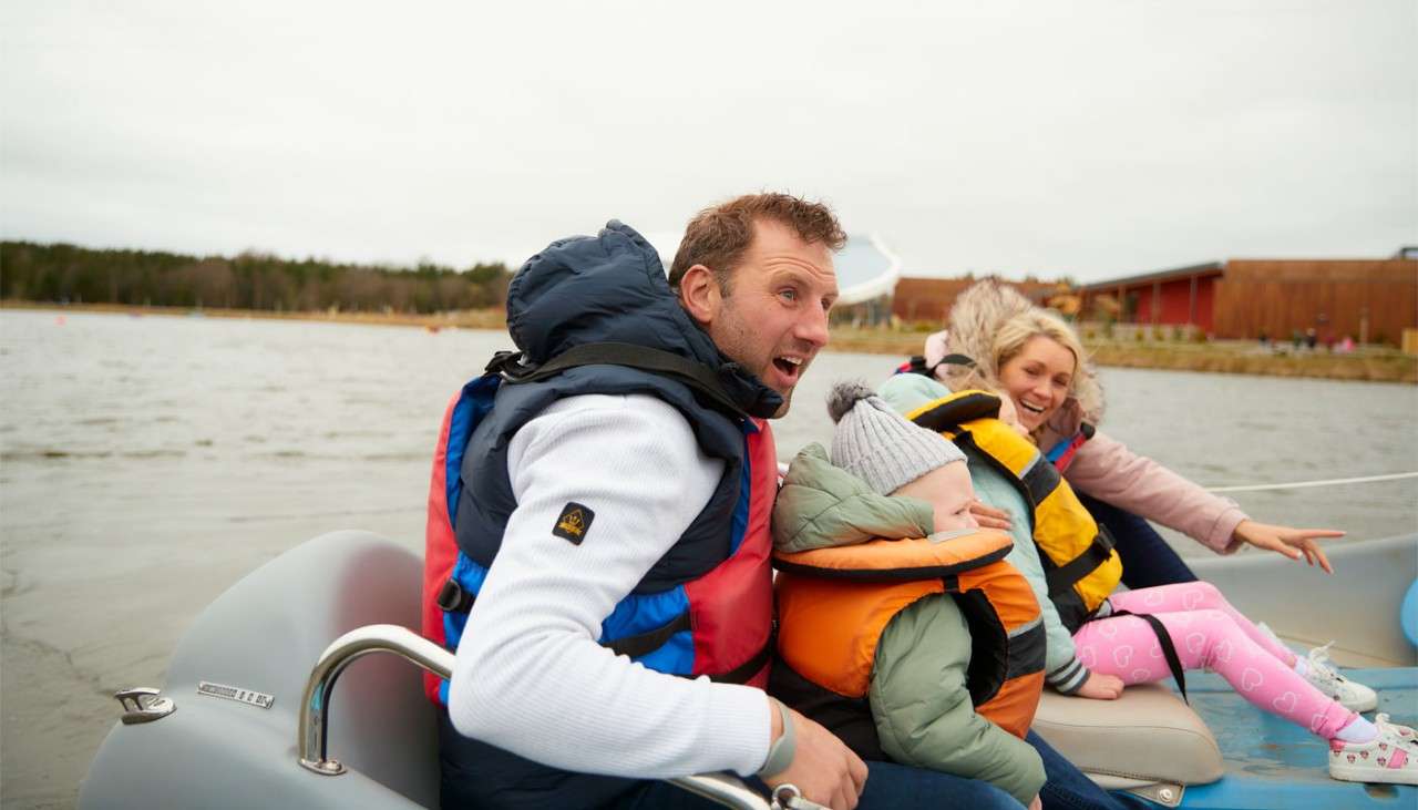 Family sitting in an electric boat