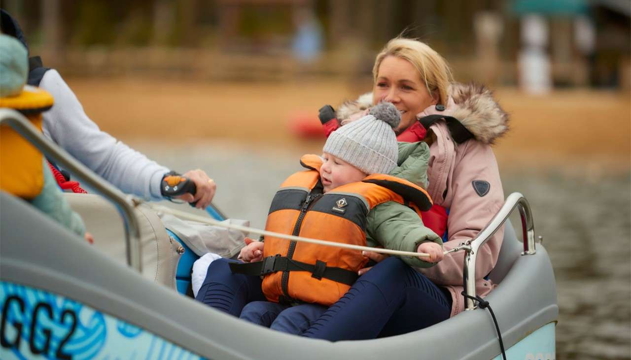 Family sitting in an electric boat