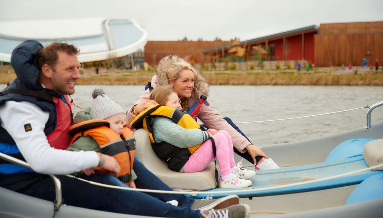 Family sitting in an electric boat