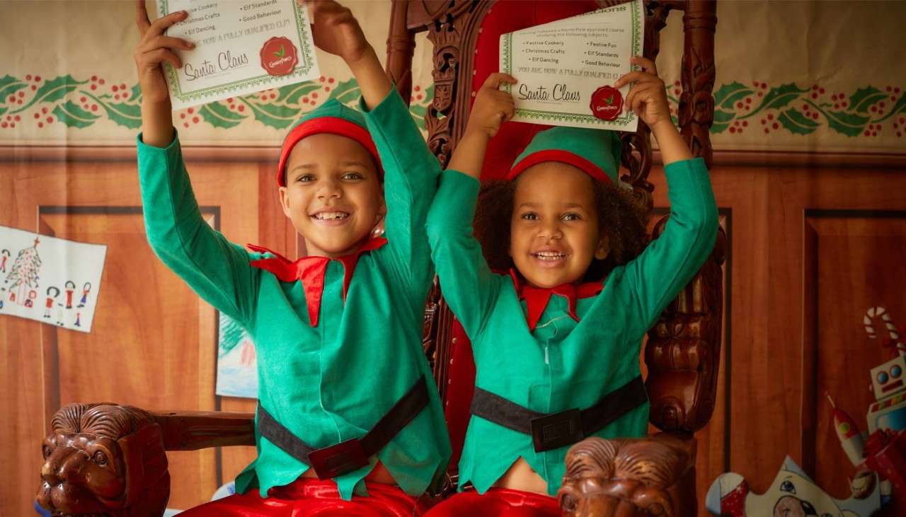 Two children holding certificates