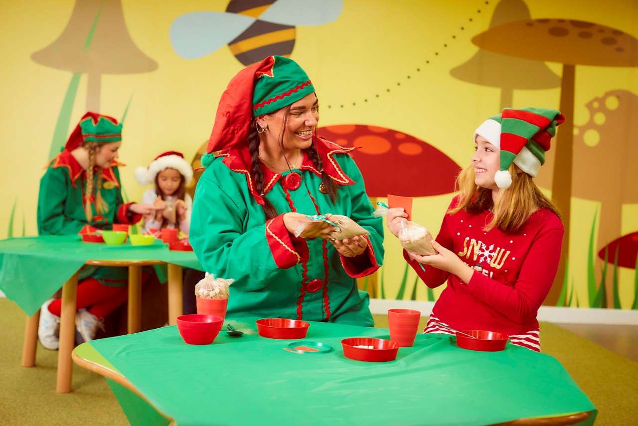 Girl with an elf taking part in the Elf Pyjama Party. 
