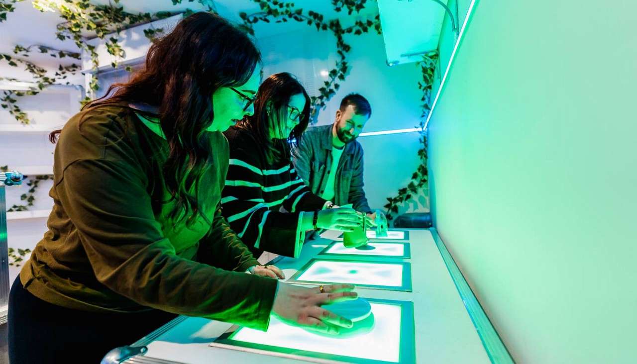 A group looking at a glowing surface in the Forest Laboratory