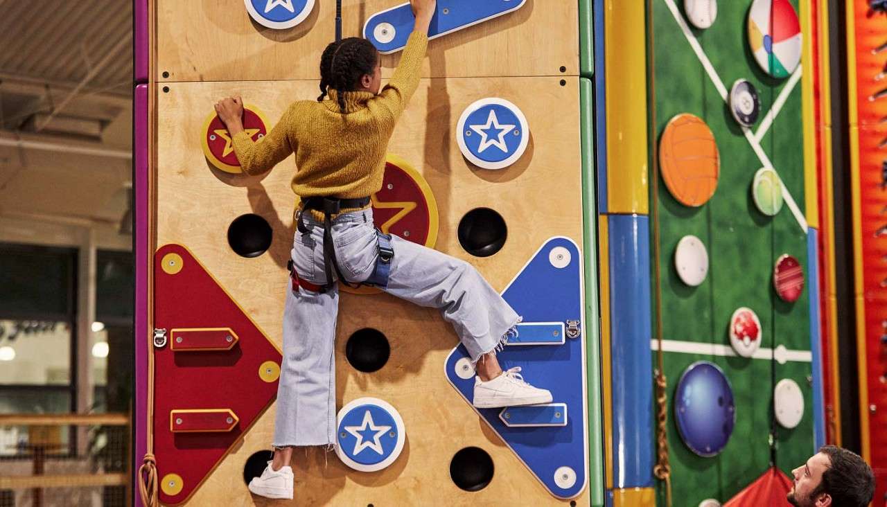 Girl scaling a climbing wall