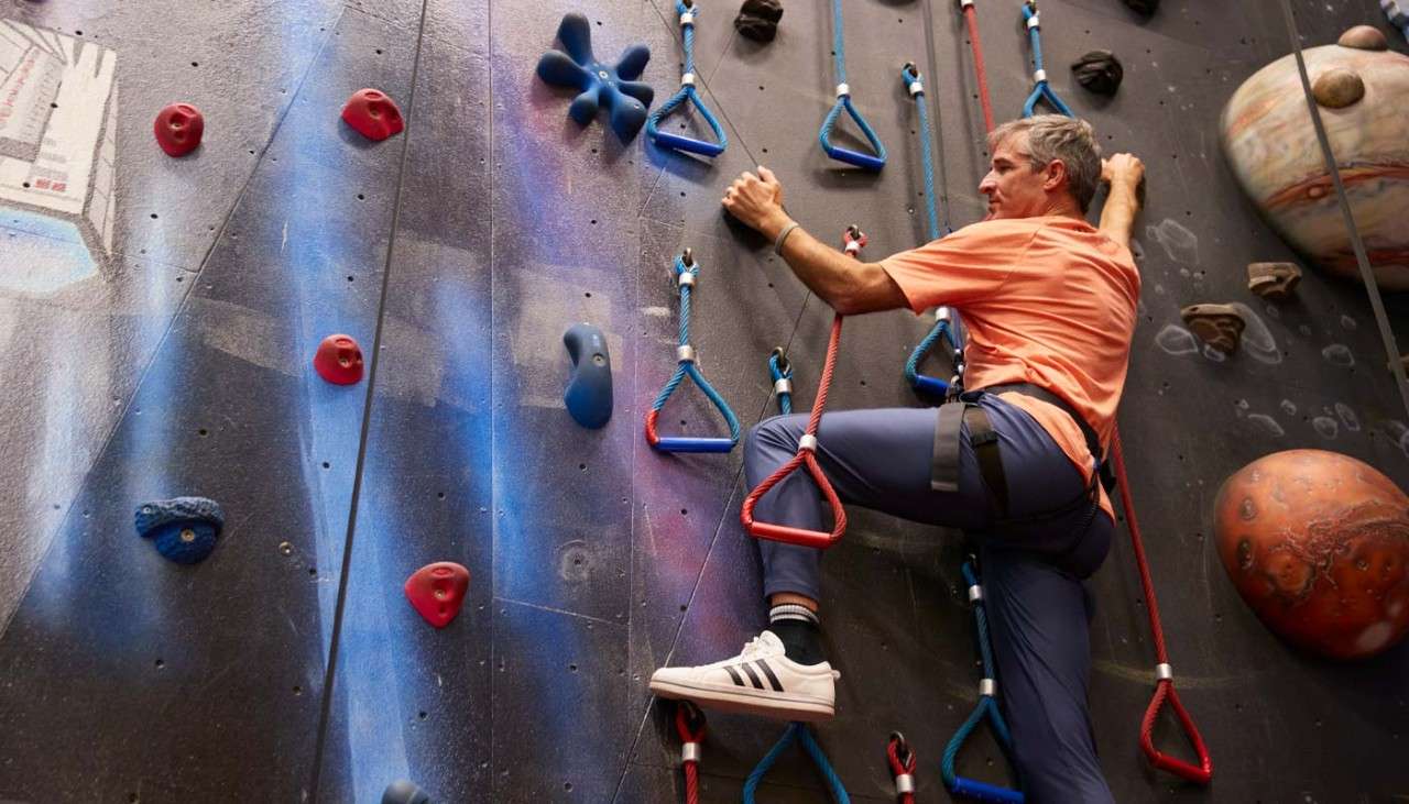 Man scaling an indoor climbing wall