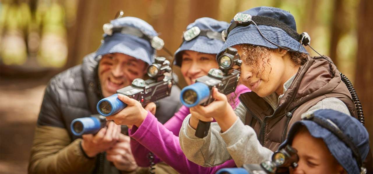 Group pointing and aiming laser guns in the Laser Combat area.