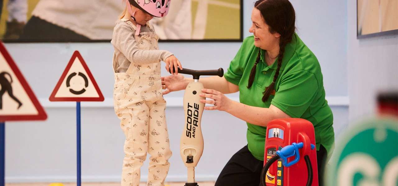 Young girl and instructor in little scooters