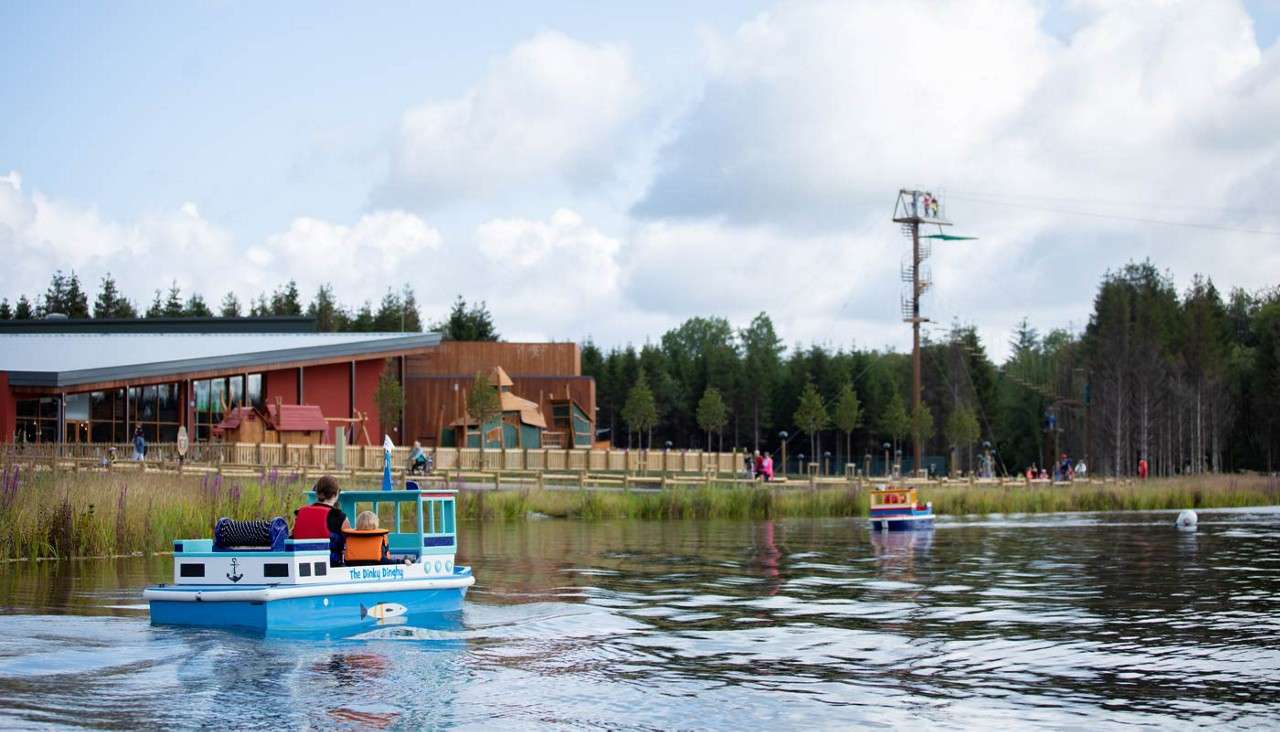 A young person sailing a mini boat