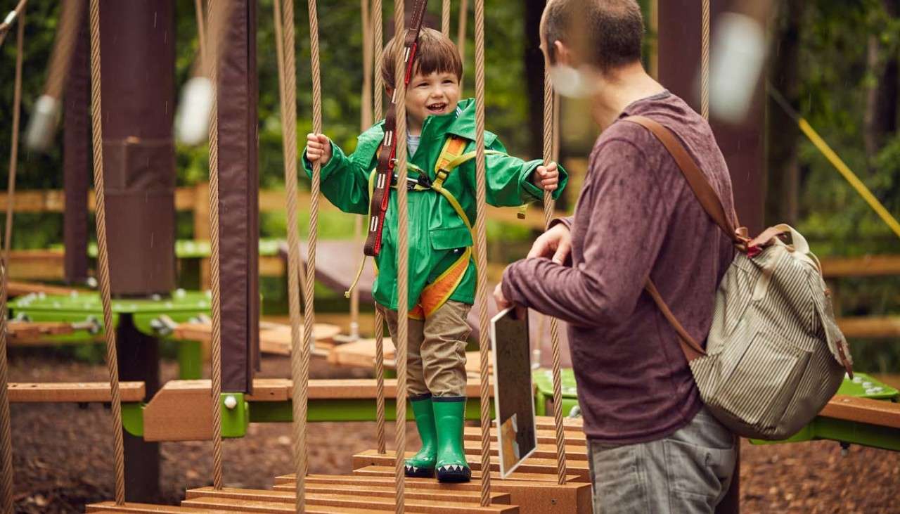 Young boy walking across the Mini Trek course