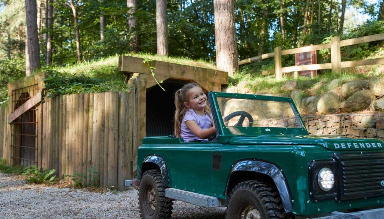 Young girl in a small car. 