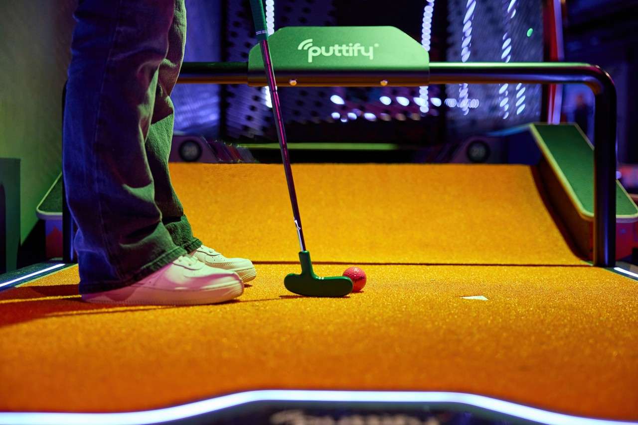 Person trying to get a hole in one.