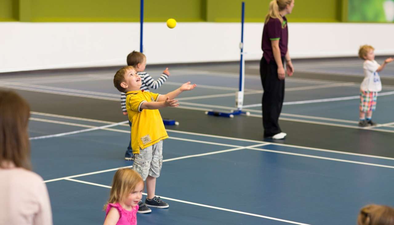 Group of young children practicing their Tennis skills
