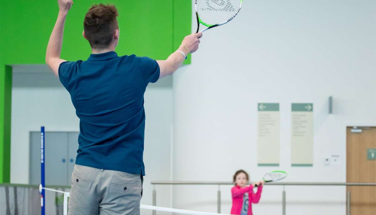 Man and young girl taking part in Short Tennis