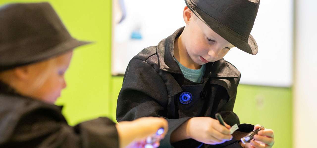 young boy taking part in spy activity 
