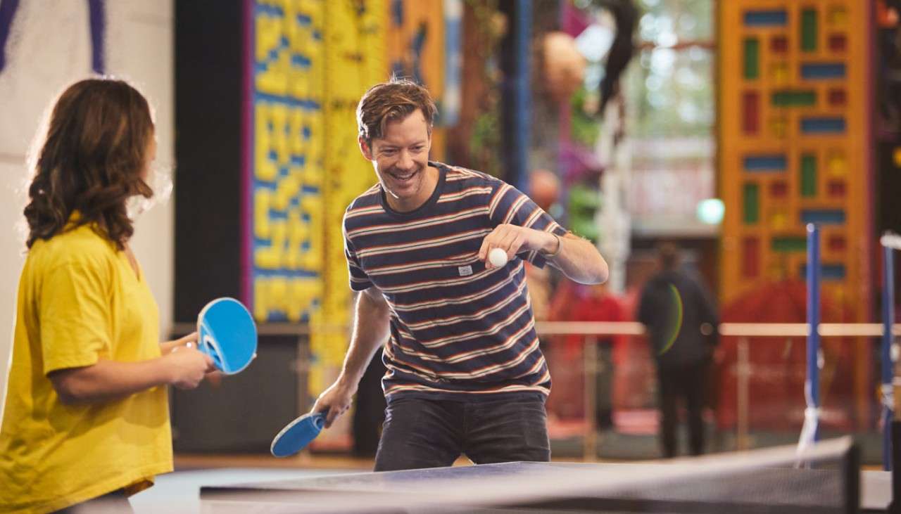 Couple playing table tennis