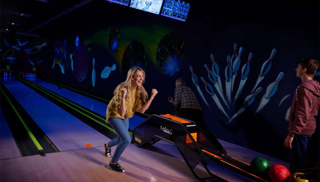 Woman celebrating after bowling